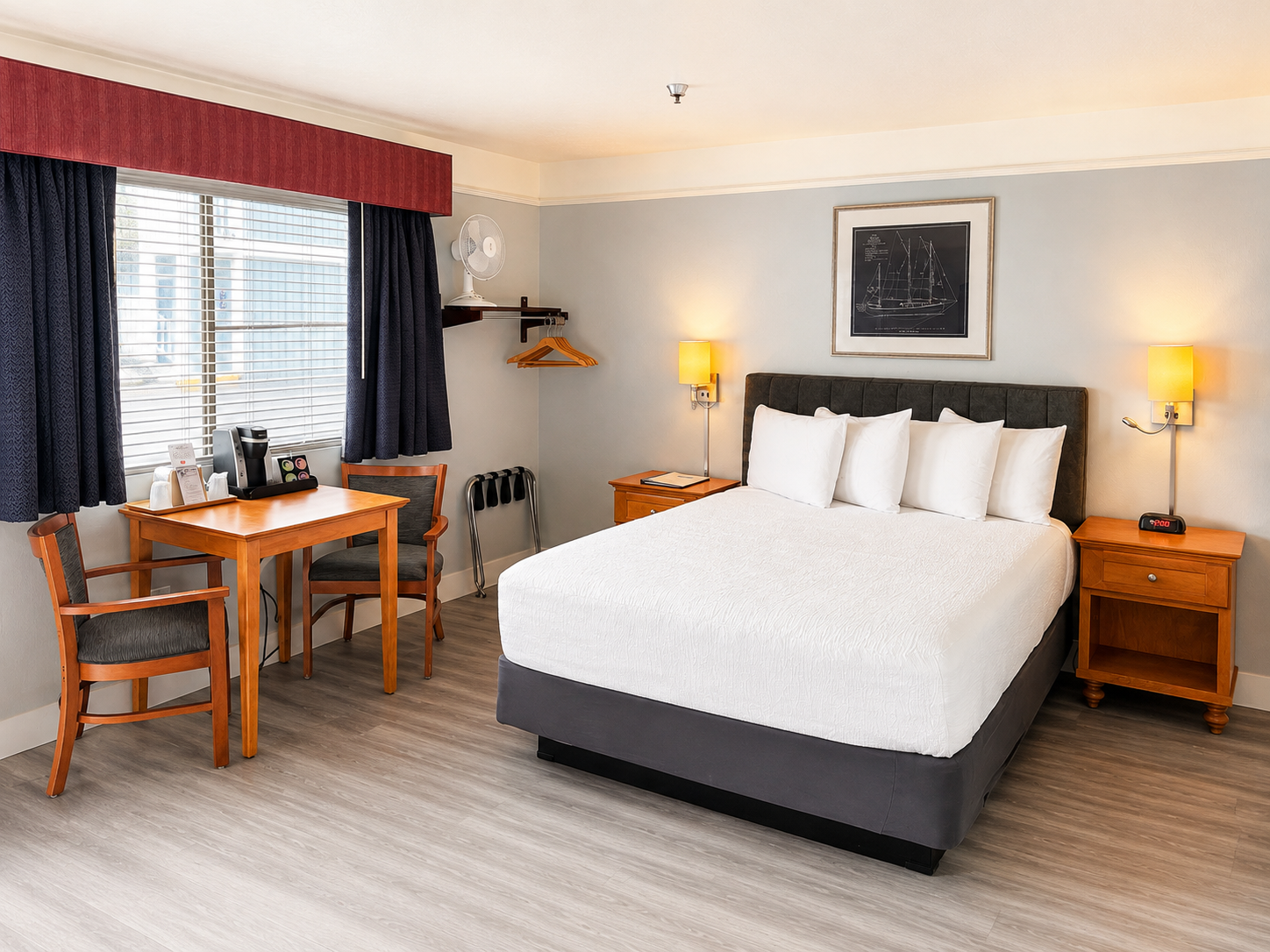 Guest room detail showing a bed, dining table, and coffee maker