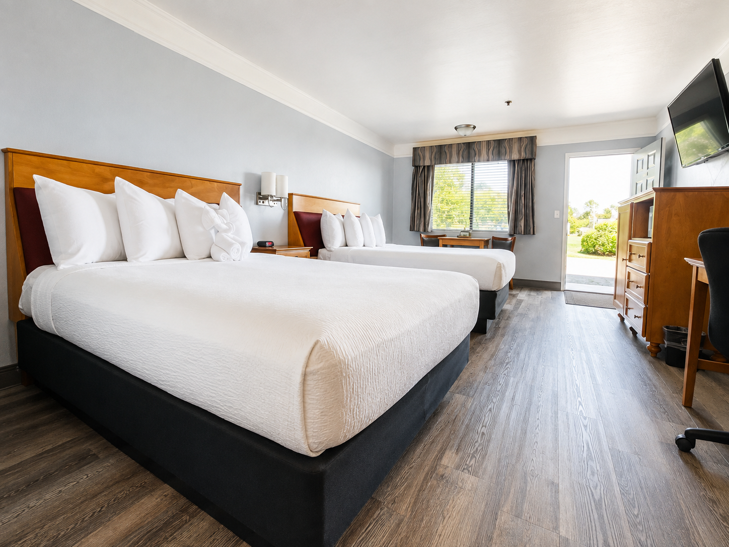 Double Queen guest room with two beds and white linens